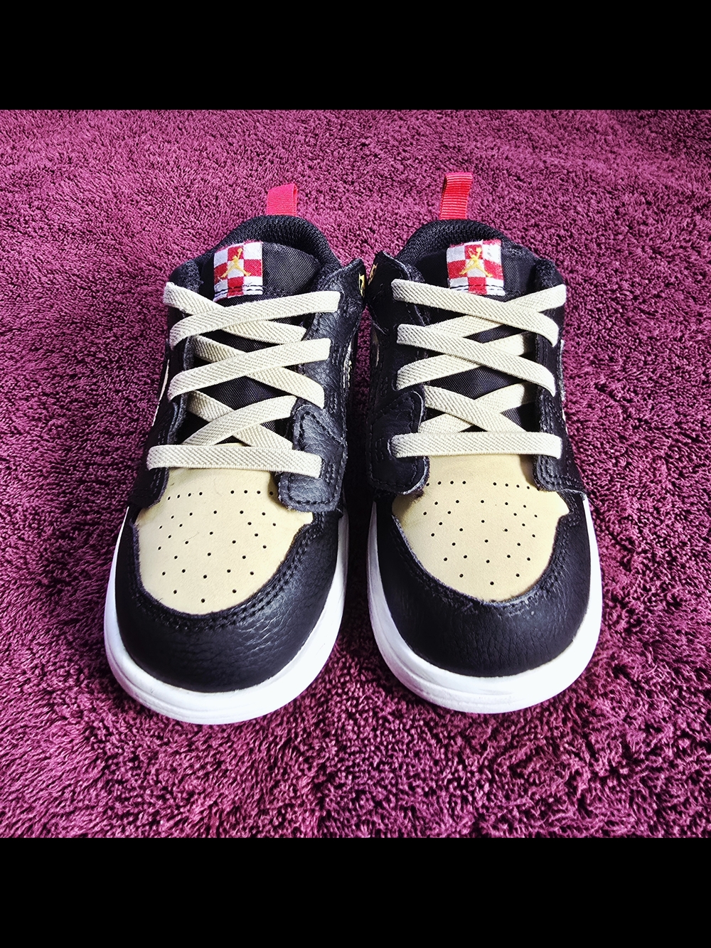 Nike Jordan Kids Black and Cream Low-Top Sneakers with Red Pull Tabs